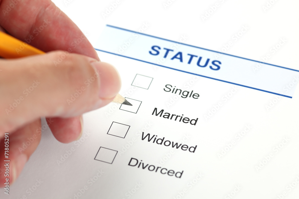 Hand marking marital status checkbox on a form for single status authentication